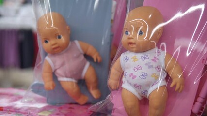 Close-up footage of packaged baby dolls displayed in retail-ready condition.