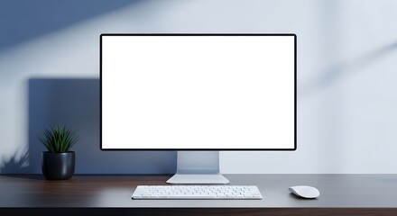 Computer monitor with a blank white screen sits on a dark desk next to a small potted plant, with a keyboard and mouse.
