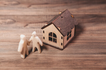 wooden house model on wooden background. real estate concept