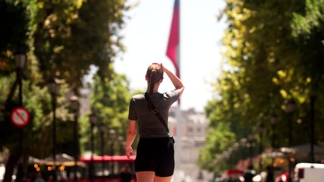 Female tourist traveller walk down Paseo Bulnes toward Plaza de La Ciudadania