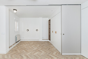 Boutique hotel room with built-in wall wardrobe and indirect lighting for a comfortable atmosphere