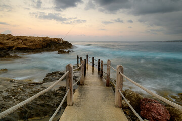 Fototapeta premium Cyprus Mediterranean Coastline with Turquoise Sea, Sandy Beach, and Clear Blue Sky