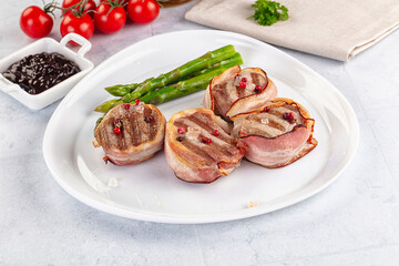 Tasty grilled pork medallion with bacon