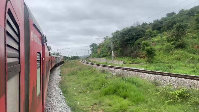 Indian Train Journey Through Green Countryside on Cloudy Day