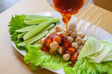 Delicious Grilled Meatballs with Spicy Sauce and Fresh Vegetables