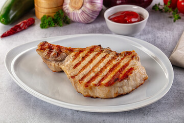Tasty hot grilled bone steak served sauce