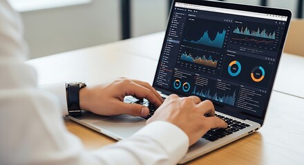 Close-up of a businessman's hands typing on a laptop, analyzing complex data charts and graphs on a modern dashboard.