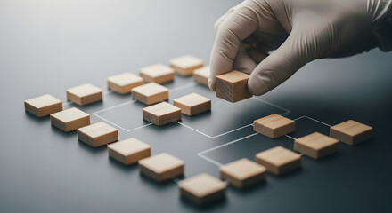 A gloved hand carefully places a wooden block, symbolizing strategic planning and network building.