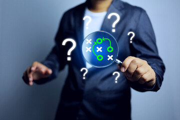 Problem solving concept with businessman holding a magnifying glass to search for method and way to get a good solution idea and result or answer