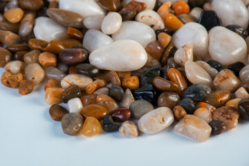 A variety of small stones of different geological origins on white background.
