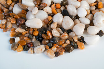 A variety of small stones of different geological origins on white background.