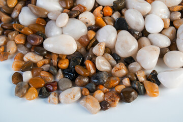 A variety of small stones of different geological origins on white background.