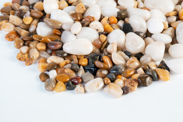 A variety of small stones of different geological origins on white background.