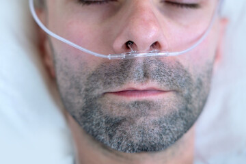 Adult male Patient with oxygen nasal cannula, man respiratory support therapy, breathing assistance...