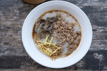 Rice porridge with minced pork and pork liver served on white bowl