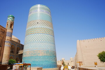 Kalta-minor Minaret and Walled Fortress known as Itchan Kala in Khiva, Uzbekistan -...