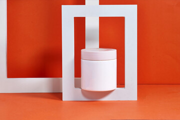Minimalistic Cosmetic Jar with Abstract Geometric White Frame on Orange Background