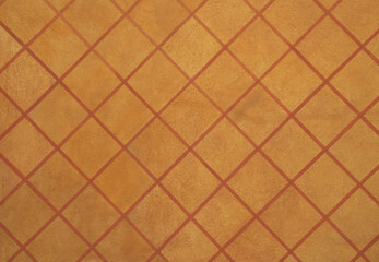High-resolution background image, warm orange brown terracotta tile wall, geometric diamond pattern. Smooth surface and clean grout lines create a rustic, vintage aesthetic. Architectural and interior