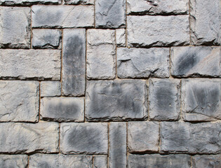 High-resolution rustic medieval gray stone wall background image. detailed masonry block pattern....