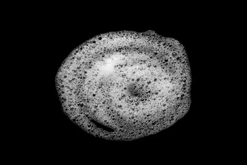 Abstract soap bubbles, shampoo or shaving cream. Isolated soap bubbles on black background with...