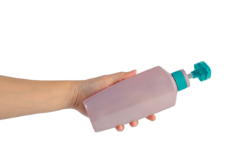 Big purple shampoo bottle in hand on transparent background