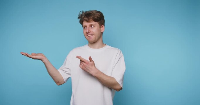 footage of young man presents a relaxed gesture, promoting a sense of ease and comfort on blue background