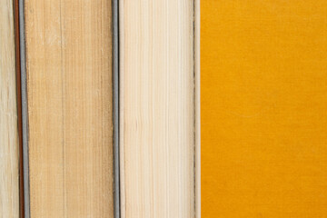 Books placed vertically with spines inward, edges of pages of different shades are visible, stand...