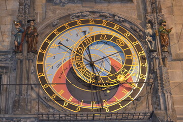 a close-up of the Prague Astronomical Clock, showcasing its intricate and golden astrolabe. This...