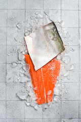 Raw fresh fillet of wild coho salmon on ice. On the kitchen surface.