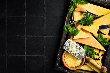 Set of hard aged cheese in a wooden box. Parmesan cheese.