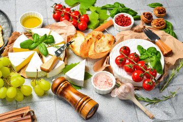 Fresh delicious Camembert cheese cut into slices Close-up, side view. Brie cheese. On a stone...