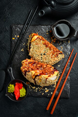 Sushi burger with fish, avocado and cheese. Japanese cuisine. Food delivery. Close-up.