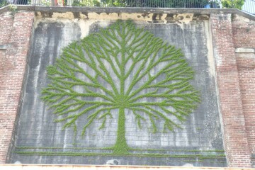 Green tree mural on a brick wall