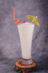 A vibrant strawberry banana smoothie with a straw in a cold glass, isolated on a white background