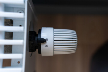 Close-up of a radiator and thermostat in a modern interior