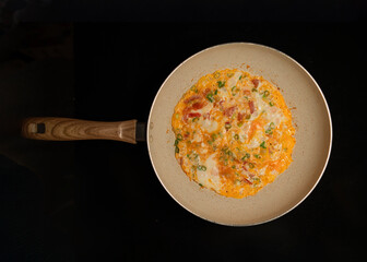 Appetizing Omelette in Skillet on Dark Background for Culinary Use