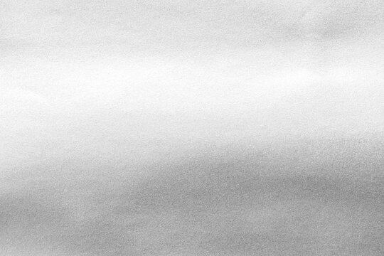 Silver background foil leaf metallic texture wrapping paper shiny glowing white grey solid reflective gradient color metal pattern backdrop for wallpaper decoration element backdrop