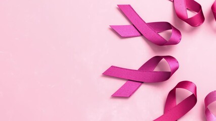 Pink ribbons on a pink background with copy space for Breast Cancer Awareness Month and World Cancer Day in stop motion style 3D animation