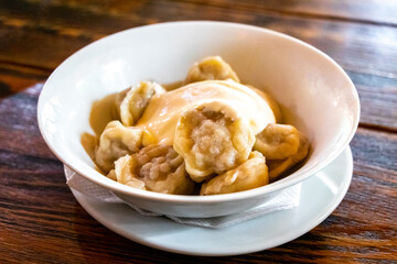 Full white bowl of pelmeni in a restaurant in Belarus.