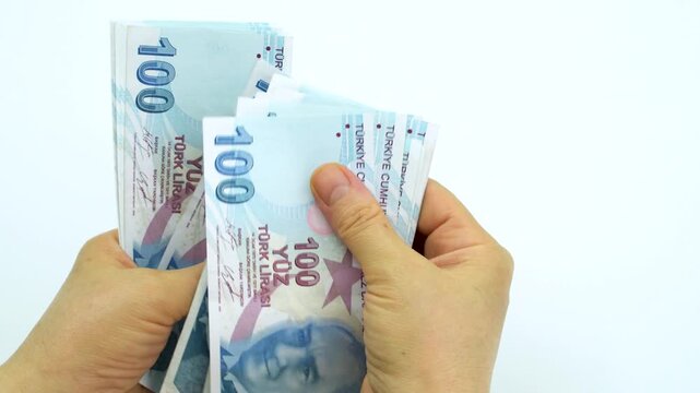 Turkish money 100 TL, female hand when calculating