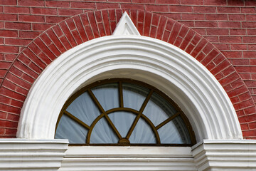 The photograph displays windows framed by attractive cladding