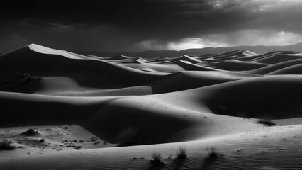Monochrome desert dunes under dramatic sky