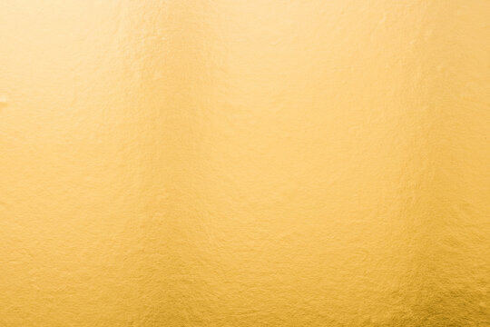 Gold background foil golden leaf metallic texture gradient light shiny reflective wrapping paper bright yellow solid color wallpaper for design decoration element backdrop - Powered by Adobe