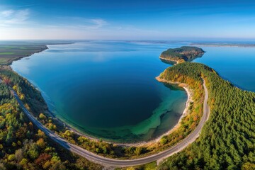 Scenic aerial view of a winding road bordering a lake
