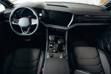 Front panel with steering wheel. Interior of the modern car, close up view