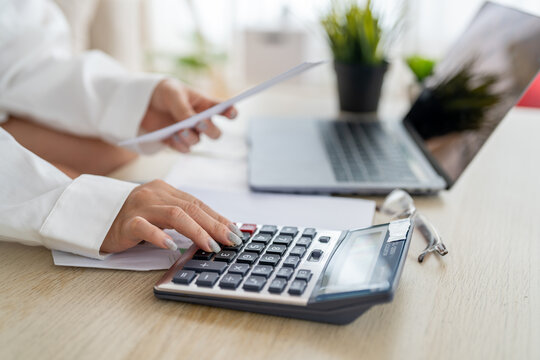 Human use calculator and calculate bills and paying bill, credit card, tax and vat, payment, concept of money management and business report with financial documents, financial accounting concept - Powered by Adobe