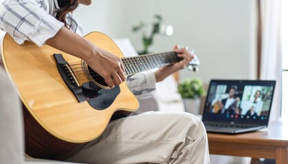 s learning to play the guitar in an online lesson from home. This student is in a virtual class with her teacher, using a laptop for music education and connection.