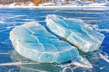 Two large, light-blue ice chunks on a frozen lake