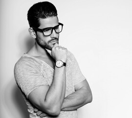 Handsome young and successful business man posing with wirst watch in formal attire