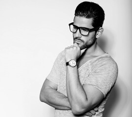 Handsome young and successful business man posing with wirst watch in formal attire